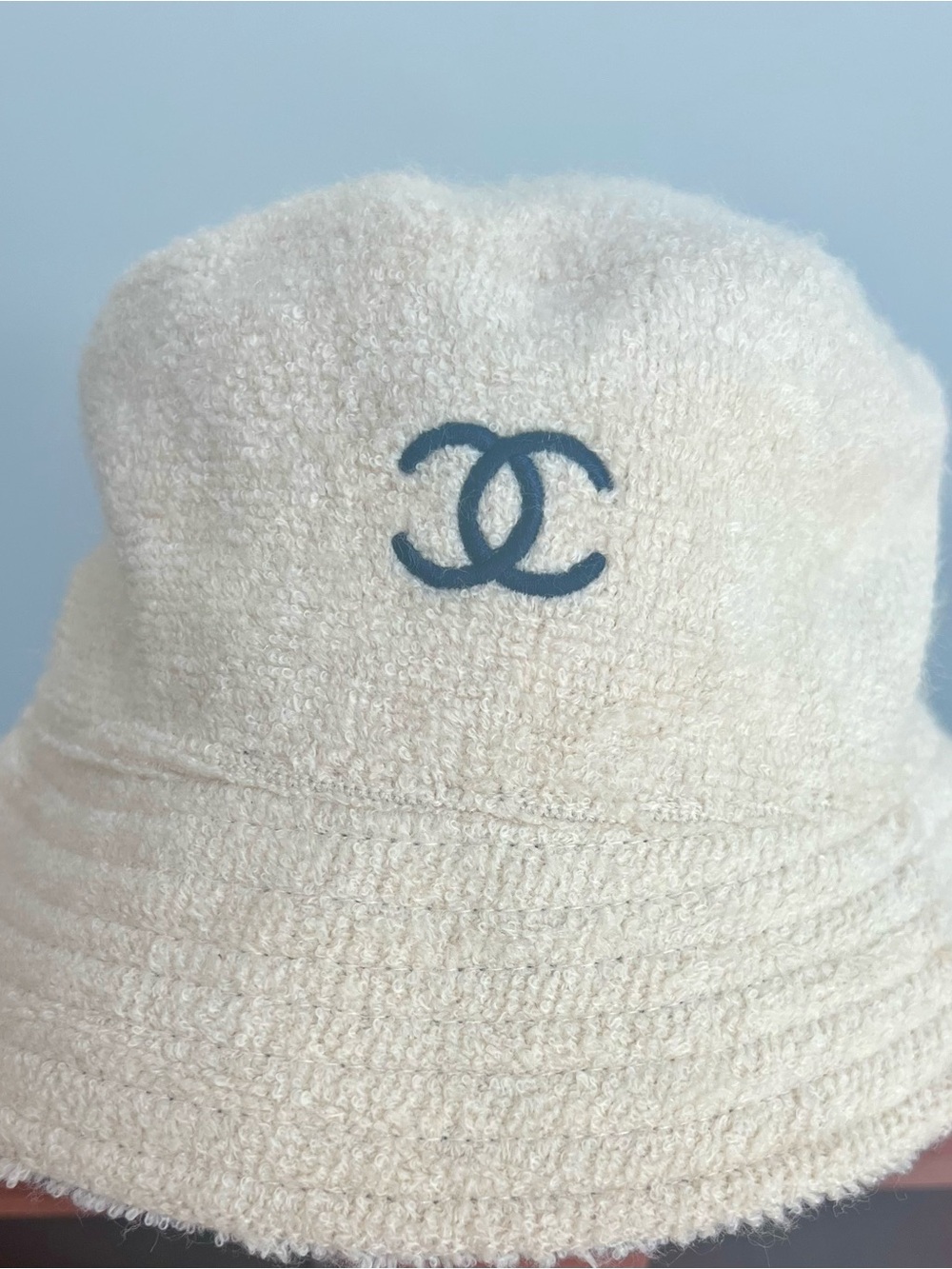 CHANEL Cream Bouclé Bucket Hat with Black CC Emblem